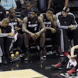 Miami Heat's LeBron James (6) sits with his teammates near the end of their loss to the San Antonio Spurs in Game 5 of their NBA Finals bask
