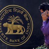 A man makes a phone call while standing near a Reserve Bank of India (RBI) crest at the RBI headquarters in Mumbai January 29, 2013. REUTERS A man makes a phone call while standing near a Reserve Bank of India (RBI) crest at the RBI headquarters in Mumbai January 29, 2013. REUTERS