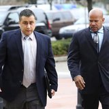 George Zimmerman is escorted by a private security guard as he arrives for a hearing in Sanford, Florida, December 11, 2012. REUTERS/Joe Bur