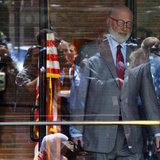 Reporters and television cameras are reflected in the glass doors as J.W. Carney, defense attorney for accused mob boss James "Whitey" Bulge Reporters and television cameras are reflected in the glass doors as J.W. Carney, defense attorney for accused mob boss James "Whitey" Bulge