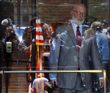 Reporters and television cameras are reflected in the glass doors as J.W. Carney, defense attorney for accused mob boss James "Whitey" Bulge Reporters and television cameras are reflected in the glass doors as J.W. Carney, defense attorney for accused mob boss James "Whitey" Bulge