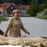 German Chancellor Angela Merkel walks on a dyke by the swollen river Elbe during a visit in Hitzacker June 12, 2013. REUTERS/Fabrizio Bensch German Chancellor Angela Merkel walks on a dyke by the swollen river Elbe during a visit in Hitzacker June 12, 2013. REUTERS/Fabrizio Bensch