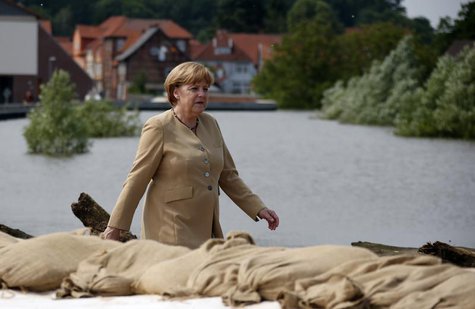 German Chancellor Angela Merkel walks on a dyke by the swollen river Elbe during a visit in Hitzacker June 12, 2013. REUTERS/Fabrizio Bensch German Chancellor Angela Merkel walks on a dyke by the swollen river Elbe during a visit in Hitzacker June 12, 2013. REUTERS/Fabrizio Bensch