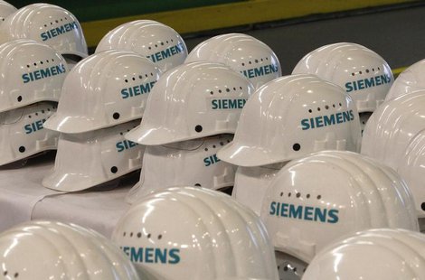 Saftey helmets are piled up for media representatives at the Siemens AG gas turbine factory hall in Berlin November 8, 2012. REUTERS/Tobias Saftey helmets are piled up for media representatives at the Siemens AG gas turbine factory hall in Berlin November 8, 2012. REUTERS/Tobias