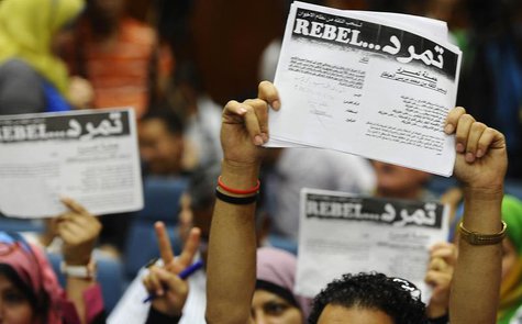 Protesters opposing Egyptian President Mohamed Mursi hold up documents from the "Tamarod" campaign during a news conference at their headqua Protesters opposing Egyptian President Mohamed Mursi hold up documents from the "Tamarod" campaign during a news conference at their headqua