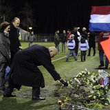 Michael van Praag, president of the Royal Dutch Football Association (KNVB), places flowers on the pitch of the soccer club Buitenboys after