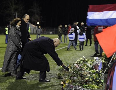 Michael van Praag, president of the Royal Dutch Football Association (KNVB), places flowers on the pitch of the soccer club Buitenboys after Michael van Praag, president of the Royal Dutch Football Association (KNVB), places flowers on the pitch of the soccer club Buitenboys after