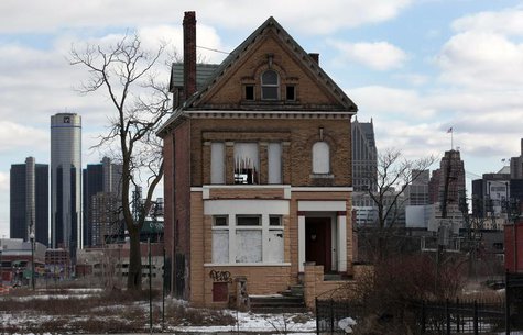 A vacant, boarded up house is seen in the once thriving Brush Park neighborhood with the downtown Detroit skyline behind it in Detroit, Mich A vacant, boarded up house is seen in the once thriving Brush Park neighborhood with the downtown Detroit skyline behind it in Detroit, Mich