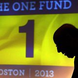 Ken Feinberg, administrator for "The One Fund, Boston" talks to a Boston Marathon bombing survivor before a town hall style meeting about th
