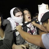 Police uses a baton to control demonstrators as they protest against the Confederation's Cup and the government of Brazil's President Dilma Police uses a baton to control demonstrators as they protest against the Confederation's Cup and the government of Brazil's President Dilma