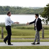 British Prime Minister David Cameron (L) welcomes Japanese Prime Minister Shinzo Abe for the first plenary session of the G8 Summit at Lough