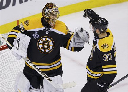 Boston Bruins' Patrice Bergeron (R) congratulates goalie Tuukka Rask after his shutout win over the Chicago Blackhawks in Game 3 of their NH Boston Bruins' Patrice Bergeron (R) congratulates goalie Tuukka Rask after his shutout win over the Chicago Blackhawks in Game 3 of their NH
