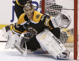 Boston Bruins goalie Tuukka Rask makes a glove save in the third period against the Chicago Blackhawks in Game 3 of their NHL Stanley Cup Fi