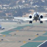 A passenger plane approaches to land as other aircraft taxi to the runway at the San Diego International Airport in San Diego, California, A A passenger plane approaches to land as other aircraft taxi to the runway at the San Diego International Airport in San Diego, California, A