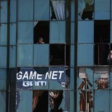 An Afghan shopkeeper removes the broken window glass of his shop near the site of an explosion in Kabul June 18, 2013. REUTERS/Mohammad Isma