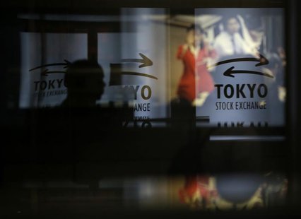 A visitor walks past logos at the Tokyo Stock Exchange in Tokyo June 13, 2013. REUTERS/Toru Hanai A visitor walks past logos at the Tokyo Stock Exchange in Tokyo June 13, 2013. REUTERS/Toru Hanai