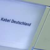 The logo of Germany's biggest cable operator, Kabel Deutschland, is written on a door bell at the Kabel Deutschland playout center in Frankf The logo of Germany's biggest cable operator, Kabel Deutschland, is written on a door bell at the Kabel Deutschland playout center in Frankf
