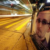 A bus passes by a poster of Edward Snowden, a former contractor at the National Security Agency (NSA), displayed by his supporters at Hong K A bus passes by a poster of Edward Snowden, a former contractor at the National Security Agency (NSA), displayed by his supporters at Hong K
