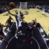 San Antonio Spurs power forward Tim Duncan (21) goes to the basket past Miami Heat shooting guard Mike Miller (13) during Game 5 of their NB