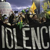 Demonstrators shout anti-government slogans behind a banner, which reads as 'violence', during one of many protests around Brazil's major ci Demonstrators shout anti-government slogans behind a banner, which reads as 'violence', during one of many protests around Brazil's major ci