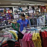 A sales assistant arranges clothing inside a V-Mart retail store in New Delhi April 6, 2013. REUTERS/Adnan Abidi A sales assistant arranges clothing inside a V-Mart retail store in New Delhi April 6, 2013. REUTERS/Adnan Abidi