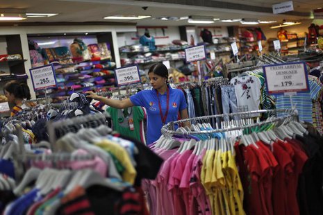 A sales assistant arranges clothing inside a V-Mart retail store in New Delhi April 6, 2013. REUTERS/Adnan Abidi A sales assistant arranges clothing inside a V-Mart retail store in New Delhi April 6, 2013. REUTERS/Adnan Abidi