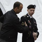 U.S. Army Private First Class Bradley Manning (R) enters the courtroom for day four of his court martial at Fort Meade, Maryland June 10, 20
