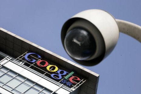 The Google logo is seen on the top of its China headquarters building behind a road surveillance camera in Beijing January 26, 2010. REUTERS The Google logo is seen on the top of its China headquarters building behind a road surveillance camera in Beijing January 26, 2010. REUTERS