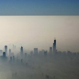Blue sky is seen over a blanket of fog enveloping the skyline of Chicago, as photographed from an airplane window November 21, 2012. REUTERS