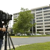 A news cameraman trains his lens on the Booz Allen Hamilton Holding Corp. building in McLean, Virginia June 11, 2013. REUTERS/Kevin Lamarque A news cameraman trains his lens on the Booz Allen Hamilton Holding Corp. building in McLean, Virginia June 11, 2013. REUTERS/Kevin Lamarque