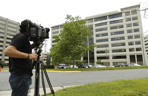 A news cameraman trains his lens on the Booz Allen Hamilton Holding Corp. building in McLean, Virginia June 11, 2013. REUTERS/Kevin Lamarque A news cameraman trains his lens on the Booz Allen Hamilton Holding Corp. building in McLean, Virginia June 11, 2013. REUTERS/Kevin Lamarque