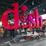 Workers build a booth for Dish, a satellite TV provider, as they prepare for the International CES show at the Las Vegas Convention Center i Workers build a booth for Dish, a satellite TV provider, as they prepare for the International CES show at the Las Vegas Convention Center i