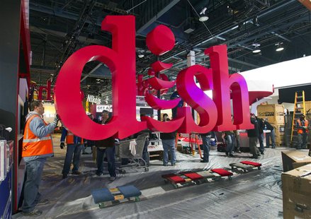 Workers build a booth for Dish, a satellite TV provider, as they prepare for the International CES show at the Las Vegas Convention Center i Workers build a booth for Dish, a satellite TV provider, as they prepare for the International CES show at the Las Vegas Convention Center i