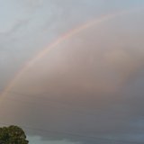 Kalamazoo Rainbow spans the west side as sunshine penetrates the rain. 