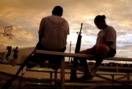 U.S. soldiers from the NATO-led coalition force relax beside a basketball court as night falls at the Kandahar Air Field, Afghanistan, June U.S. soldiers from the NATO-led coalition force relax beside a basketball court as night falls at the Kandahar Air Field, Afghanistan, June