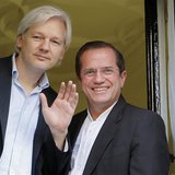 WikiLeaks founder Julian Assange waves from a window with Ecuador's Foreign Affairs Minister Ricardo Patino (R) at Ecuador's embassy in cent