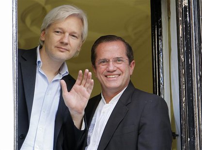 WikiLeaks founder Julian Assange waves from a window with Ecuador's Foreign Affairs Minister Ricardo Patino (R) at Ecuador's embassy in cent WikiLeaks founder Julian Assange waves from a window with Ecuador's Foreign Affairs Minister Ricardo Patino (R) at Ecuador's embassy in cent