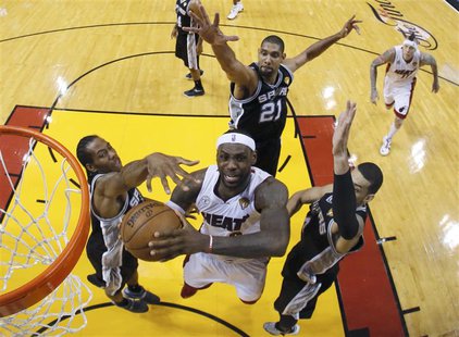 Miami Heat small forward LeBron James (6) goes to the basket past San Antonio Spurs' Tim Duncan (21), Danny Green (4) and Kawhi Leonard (2) Miami Heat small forward LeBron James (6) goes to the basket past San Antonio Spurs' Tim Duncan (21), Danny Green (4) and Kawhi Leonard (2)