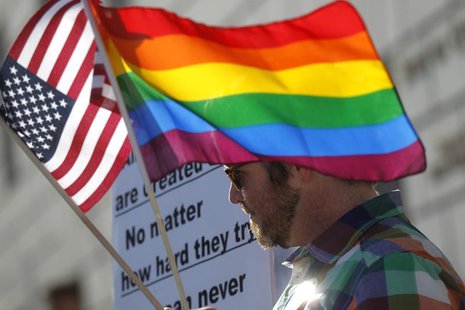 A man carries flags at a rally in support of same-sex marriage at the State of California Supreme Court in San Francisco, California March 2 A man carries flags at a rally in support of same-sex marriage at the State of California Supreme Court in San Francisco, California March 2
