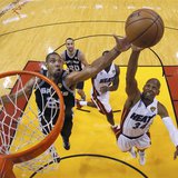 San Antonio Spurs power forward Tim Duncan (21) and Miami Heat shooting guard Ray Allen (34) reach for a rebound during Game 6 of their NBA 