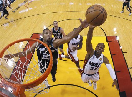 San Antonio Spurs power forward Tim Duncan (21) and Miami Heat shooting guard Ray Allen (34) reach for a rebound during Game 6 of their NBA San Antonio Spurs power forward Tim Duncan (21) and Miami Heat shooting guard Ray Allen (34) reach for a rebound during Game 6 of their NBA