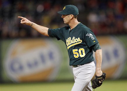 Oakland Athletics pitcher Grant Balfour points to left field after getting the last out against the Texas Rangers in the ninth inning of the Oakland Athletics pitcher Grant Balfour points to left field after getting the last out against the Texas Rangers in the ninth inning of the