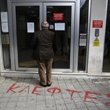 A depositor waits to enter a Laiki Bank branch in Nicosia March 28, 2013. REUTERS/Yannis Behrakis A depositor waits to enter a Laiki Bank branch in Nicosia March 28, 2013. REUTERS/Yannis Behrakis