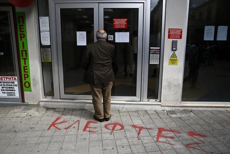 A depositor waits to enter a Laiki Bank branch in Nicosia March 28, 2013. REUTERS/Yannis Behrakis A depositor waits to enter a Laiki Bank branch in Nicosia March 28, 2013. REUTERS/Yannis Behrakis