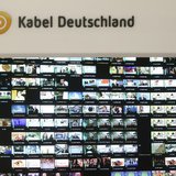The logo of Germany's biggest cable operator, Kabel Deutschland, is pictured above a monitor wall at the Kabel Deutschland playout center in