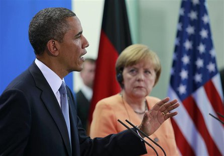 U.S. President Barack Obama speaks next to German Chancellor Angela Merkel during a news conference after their meeting at the Chancellery i U.S. President Barack Obama speaks next to German Chancellor Angela Merkel during a news conference after their meeting at the Chancellery i