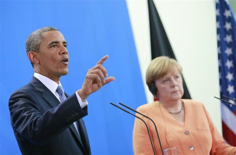 U.S. President Barack Obama speaks next to German Chancellor Angela Merkel (R) during a news conference after their meeting at the Chancelle U.S. President Barack Obama speaks next to German Chancellor Angela Merkel (R) during a news conference after their meeting at the Chancelle