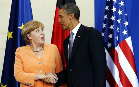 U.S. President Barack Obama and German Chancellor Angela Merkel shake hands at the end of a joint news conference at the Chancellery in Berl U.S. President Barack Obama and German Chancellor Angela Merkel shake hands at the end of a joint news conference at the Chancellery in Berl