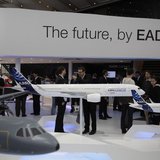 Visitors look at aircraft models at the EADS booth during the ILA Berlin Air Show in Selchow near Schoenefeld south of Berlin, September 13,