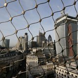 The City of London business district is seen through a wire fence in London February 28, 2013. REUTERS/Stefan Wermuth The City of London business district is seen through a wire fence in London February 28, 2013. REUTERS/Stefan Wermuth